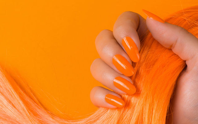 https://skinkraft.com/cdn/shop/articles/female-hand-orange-nails-holding-hair_1024x400.jpg?v=1598001637